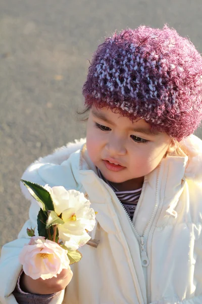 Adorable child looking at flowers — Stock Photo, Image