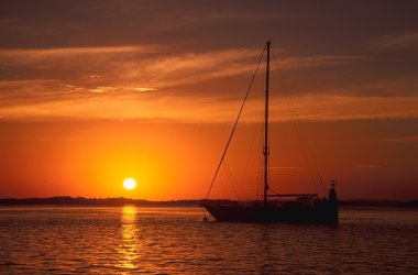 Yacht at sunset clipart