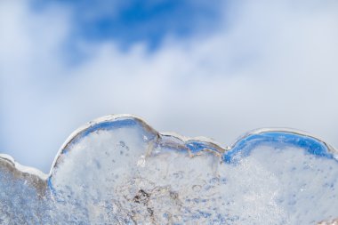 Cloud Similar ice sculpture with a blue sky with clouds clipart