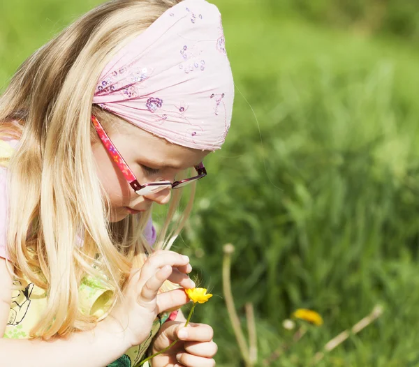 Girl picking yellow spring flower — Stock Photo, Image