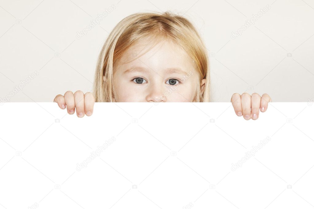 Child behind white board