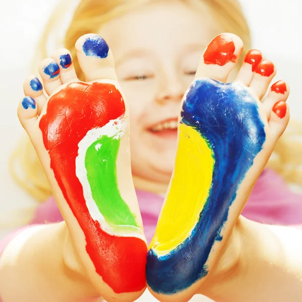 Little girl with feet painted — Stock Photo, Image