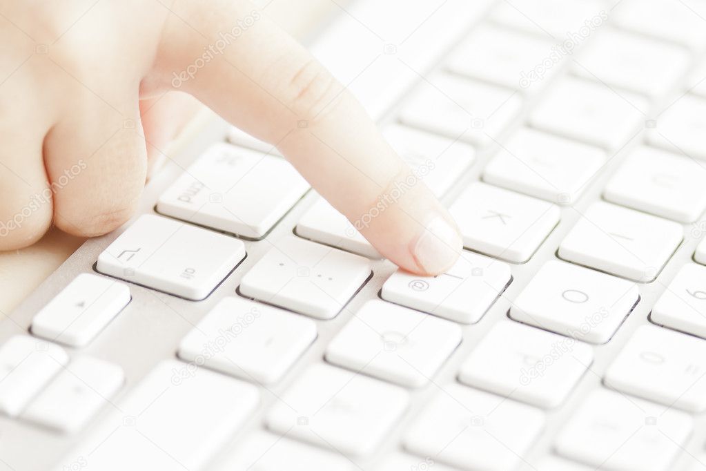 Hands of child on computer keyboard