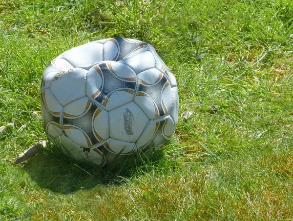 Punctured football — Stock Photo, Image