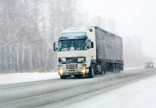 Truck goes on winter road — Stock Photo, Image