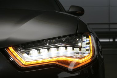 Headlight of prestigious car close up clipart