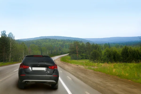 stock image Car goes on country road