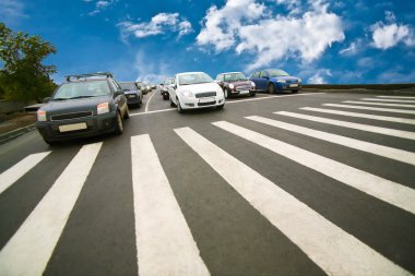 Cars stopped on pedestrian crossing clipart