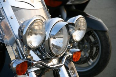 Three chromeplated headlights. clipart