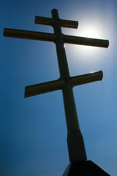Metal cross in the solar sky — Stock Photo, Image
