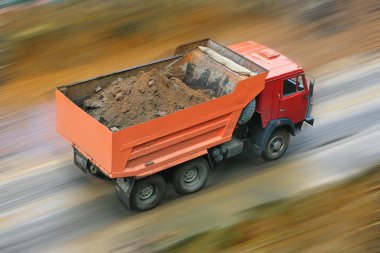 Dump truck goes on road clipart