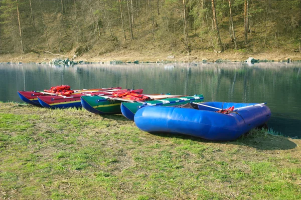 Catamarans and inflatable boat ashore — Stock Photo, Image