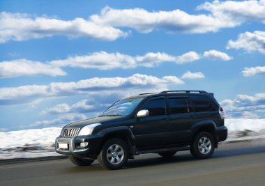 SUV goes on winter road clipart