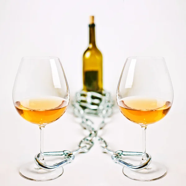Glasses of light wine chain and bottle — Stock Photo, Image