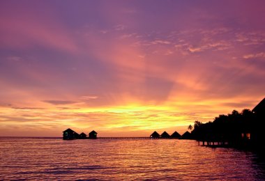 Sunset over the island. clipart