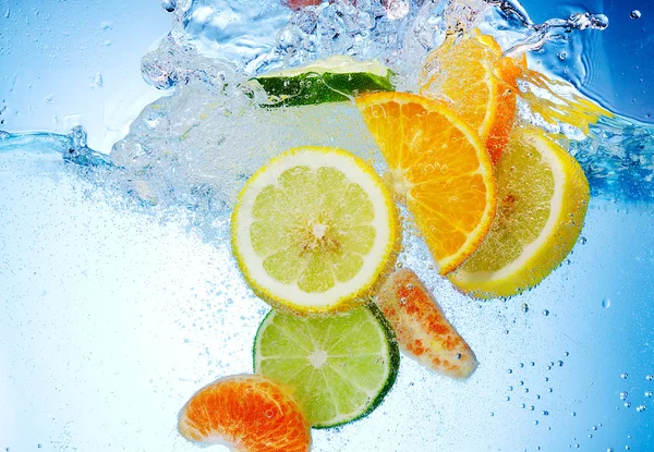 Fruits are falling under water with a splash — Stock Photo, Image