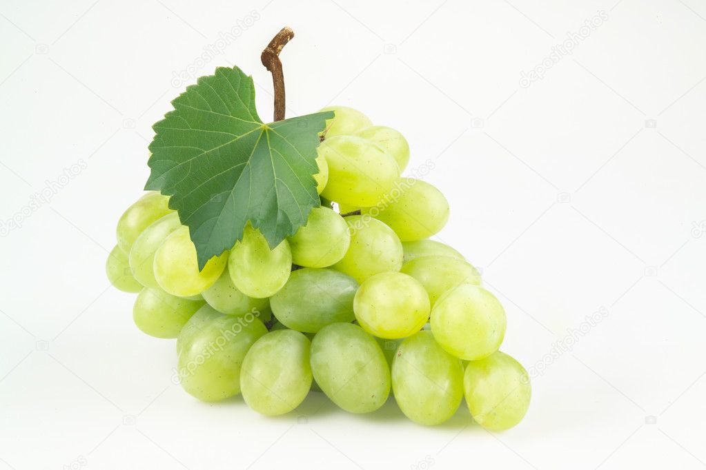 Green grapes with leaf. Isolated on white