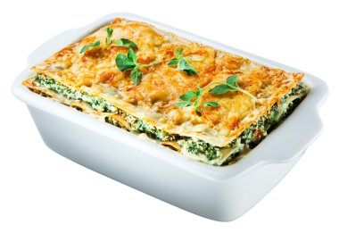 Spinach lasagna with basil and oregano Isolated. Clipping path clipart
