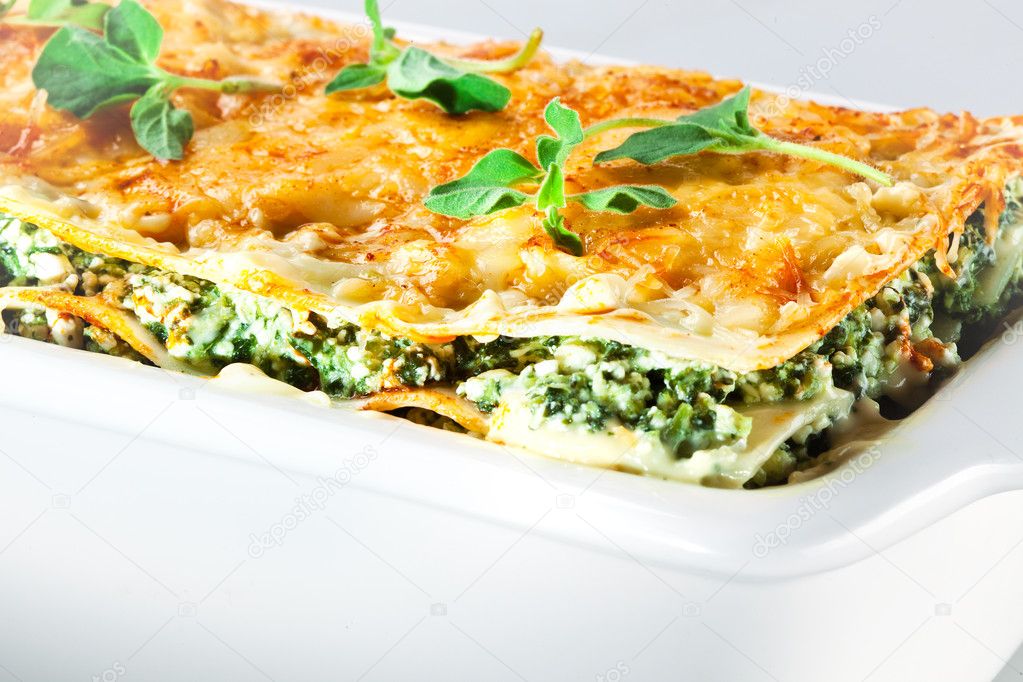 Italian cuisine. Spinach lasagna with basil. Macro