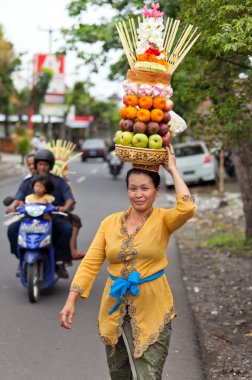 Woman carrying offerings clipart