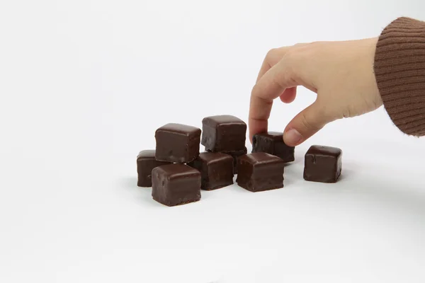 Ruka a čokoláda — Stock fotografie