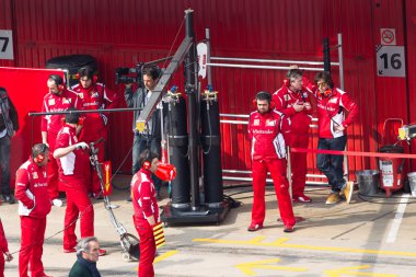 Fernando Alonso (ESP) talking to Ferrari mechanic clipart