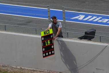 Mechanic showing laps to Nico - Testing Days Barcelona clipart