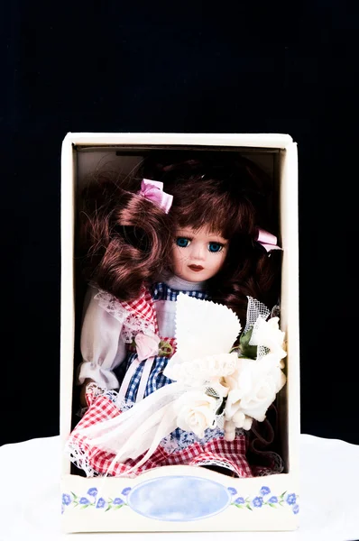 Old doll in the box — Stock Photo, Image