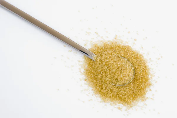 Brown sugar on silver teaspoon — Stock Photo, Image