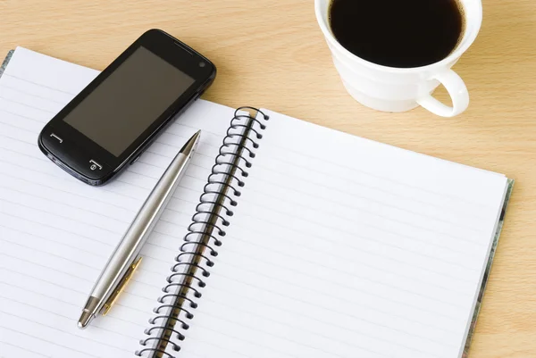 Cell phone, notebook and cup of coffee — Stock Photo, Image