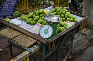 Green mangos in Vietnamese street markets clipart