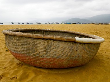 Vietnamese boat on the beach clipart