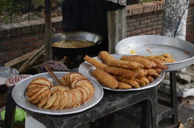 Fried green banana and other Vietnamese sweets from the street stands clipart