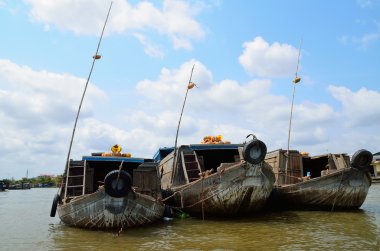 Pumpkin boat sellers at floating market clipart