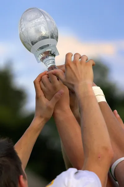 Hands reaching for a trophy — Stock Photo, Image