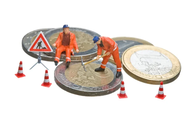 stock image Miniature figures working on a heap of Euro coins.