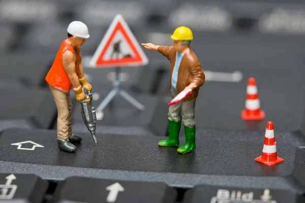 stock image Miniature figures working on a computer keyboard.