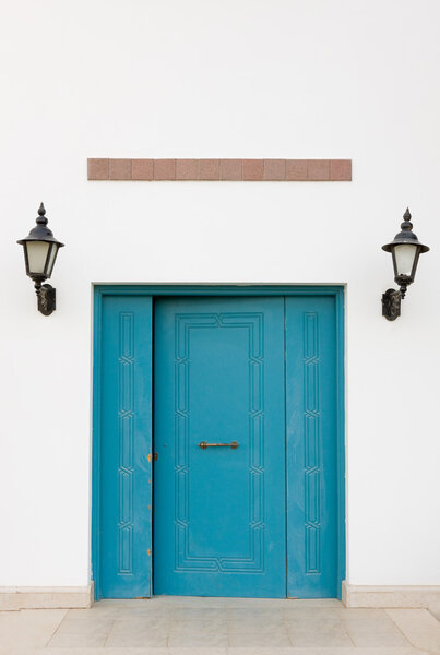 Photo of a blue wooden door.