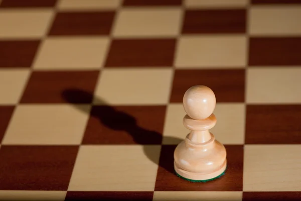 Chess piece - a white pawn on a chessboard. — Stock Photo, Image