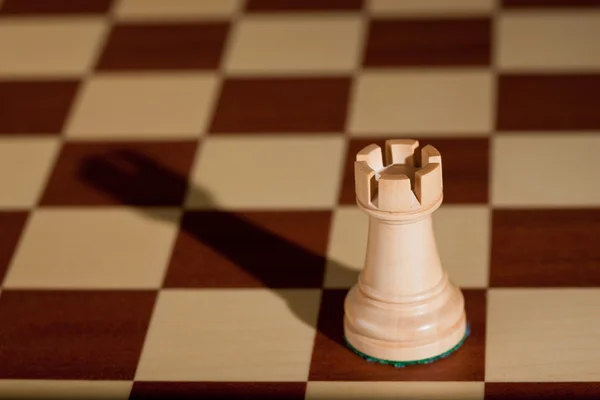 Chess piece - a white rook on a chessboard. — Stock Photo, Image