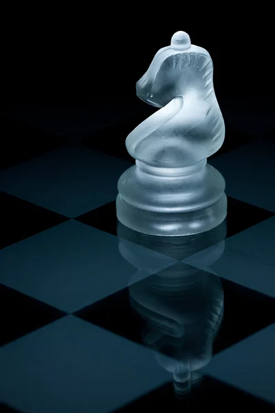 Macro shot of glass chess knight against a black background — Stock Photo, Image