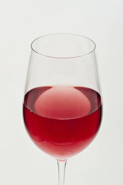 Glass of red wine in soft white light — Stock Photo, Image