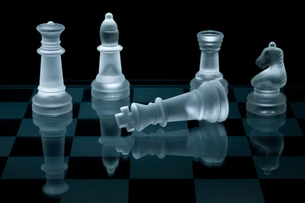 Macro shot of glass chess pieces against a black background Royalty Free Stock Photos