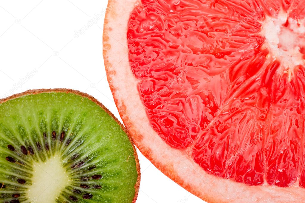 Macro shot of a red grapefruit and a kiwi isolated on white