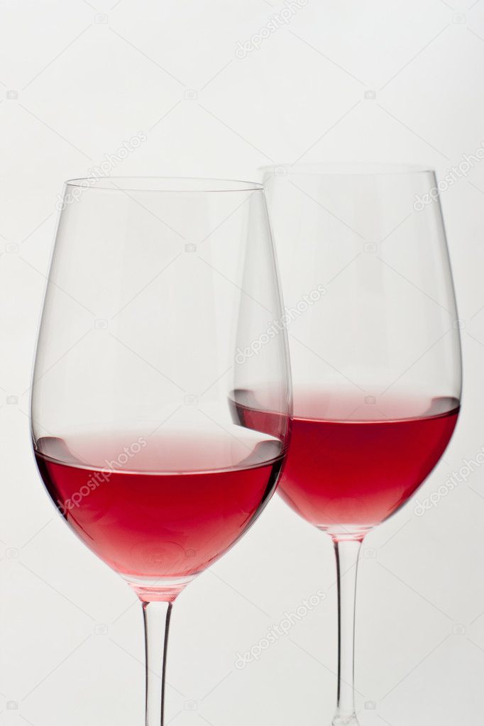 Two glasses of red wine in soft white light