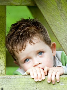Sad little boy with bright blue eyes clipart