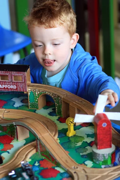 Little boy playing with his wooden train set — Stock Photo, Image