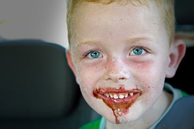 Litre boy eating a chocolate ice cream clipart