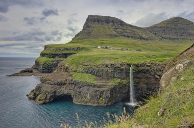 Steep green hills in the Faroe Islands clipart