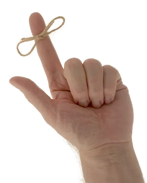 Hand with reminder string on finger — Stock Photo, Image